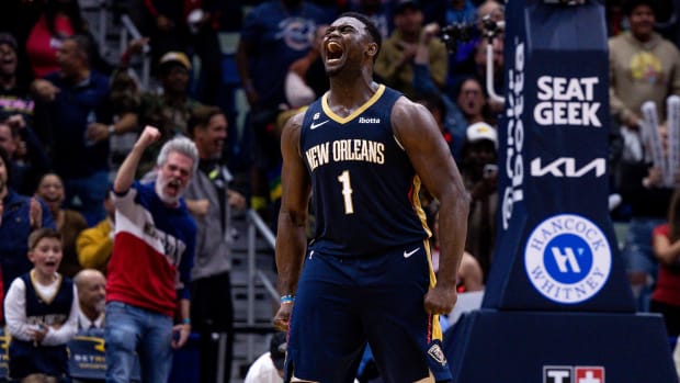 Zion Williamson looks up and yells in celebration with his arms flexed by his side